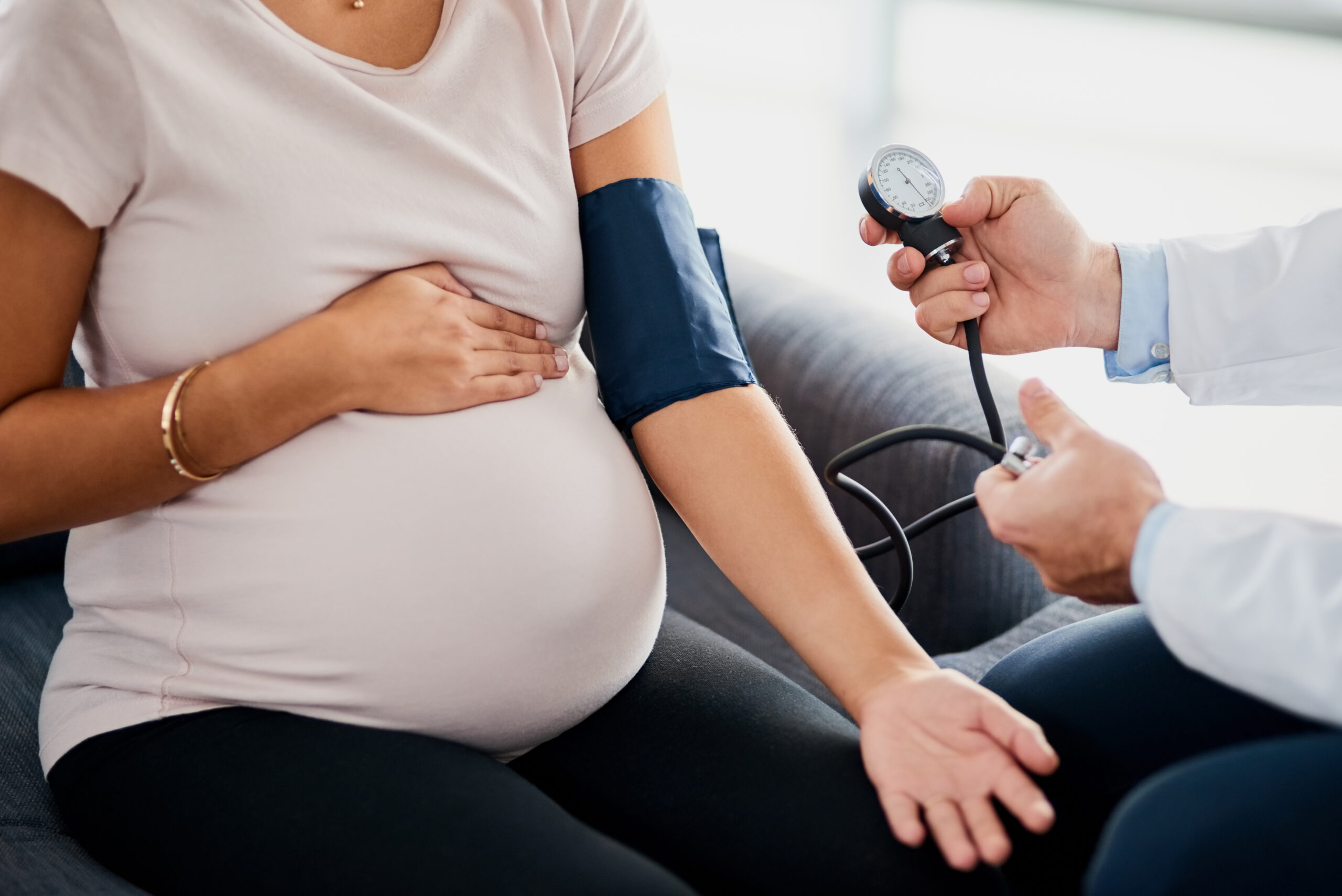 Closeup shot of a doctor checking a pregnant woman's blood pressure