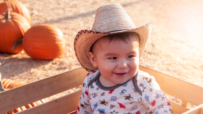 Baby wearing a cowboy hat