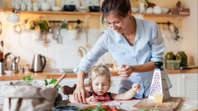 A mother helping her daughter in the kitchen
