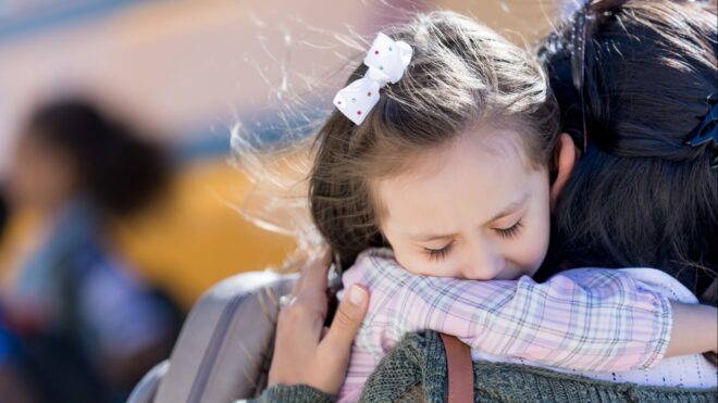 A mom holding her daughter