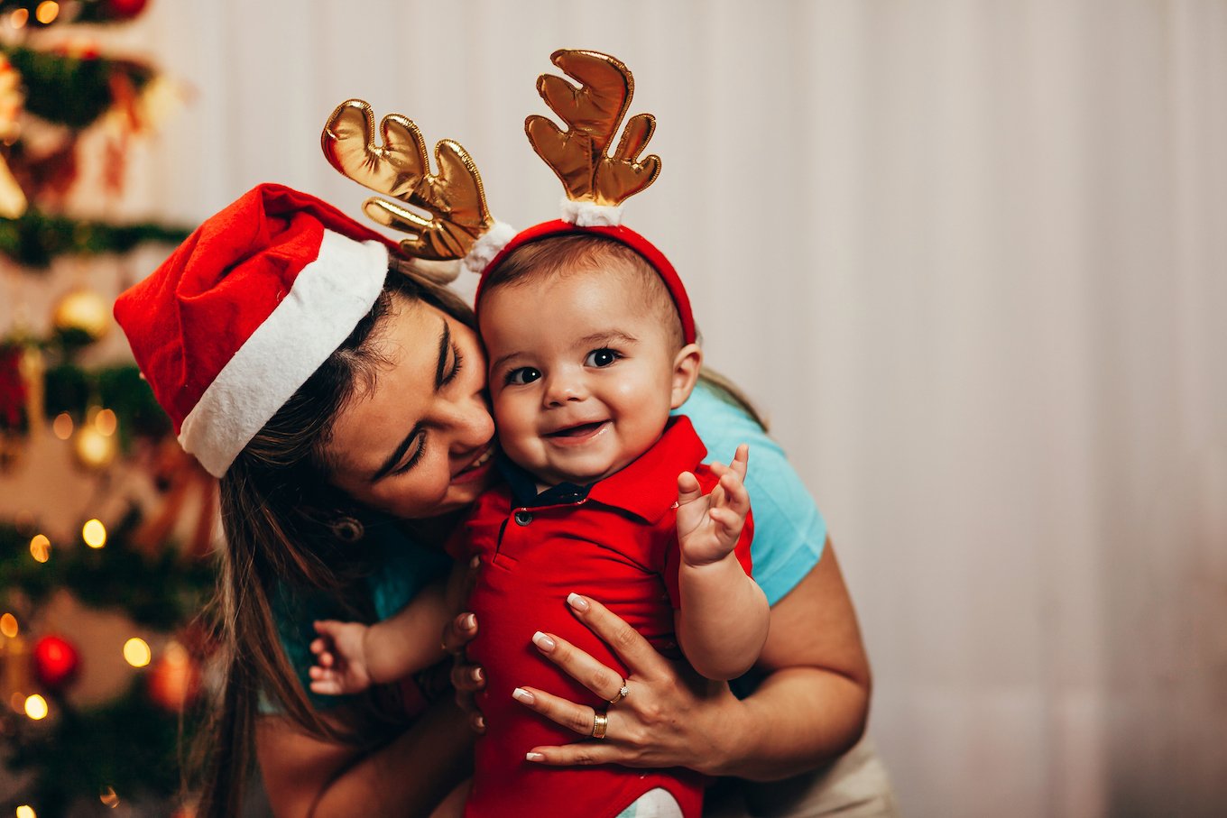 Baby wearing reindeer antlers