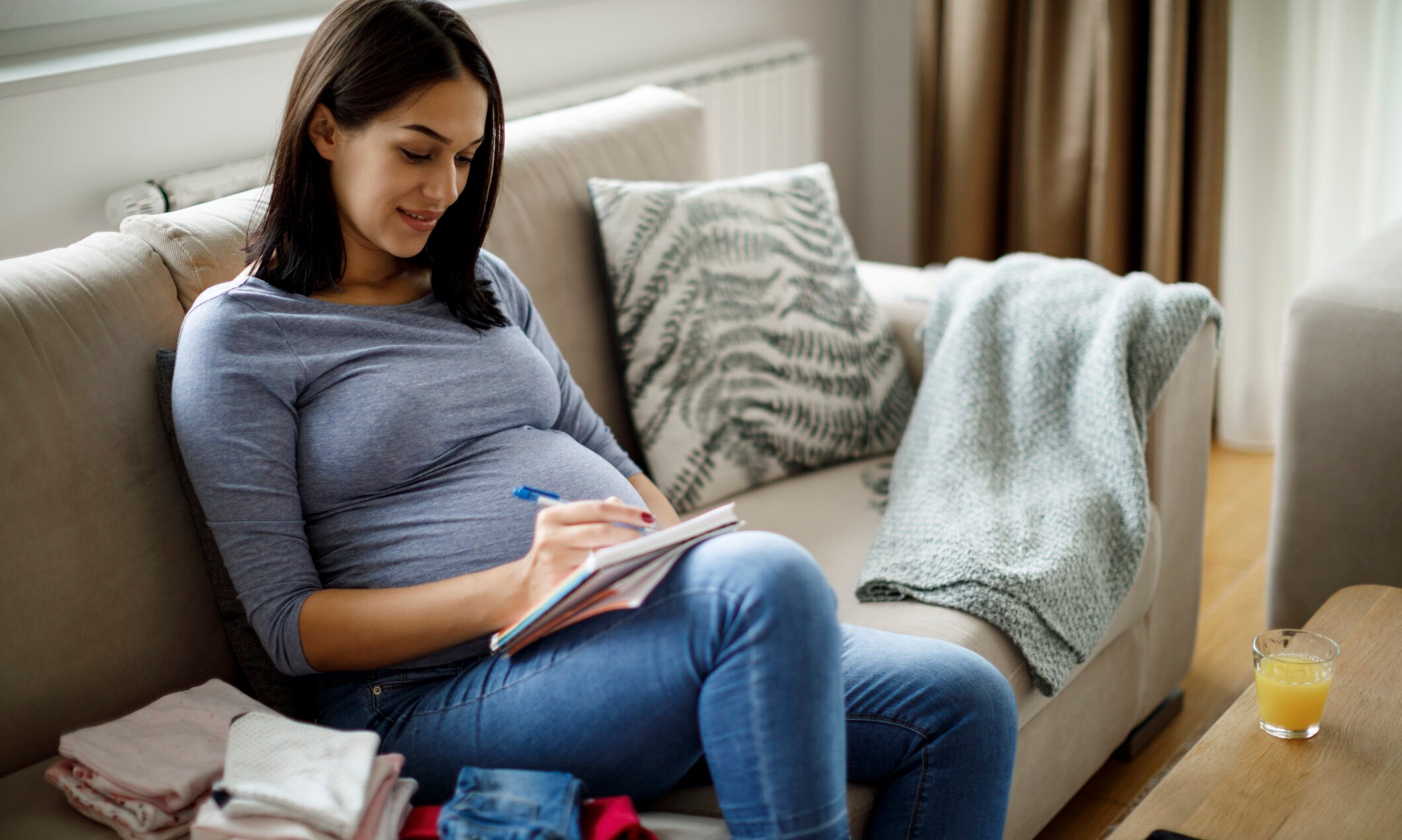 Pregnant woman making notes