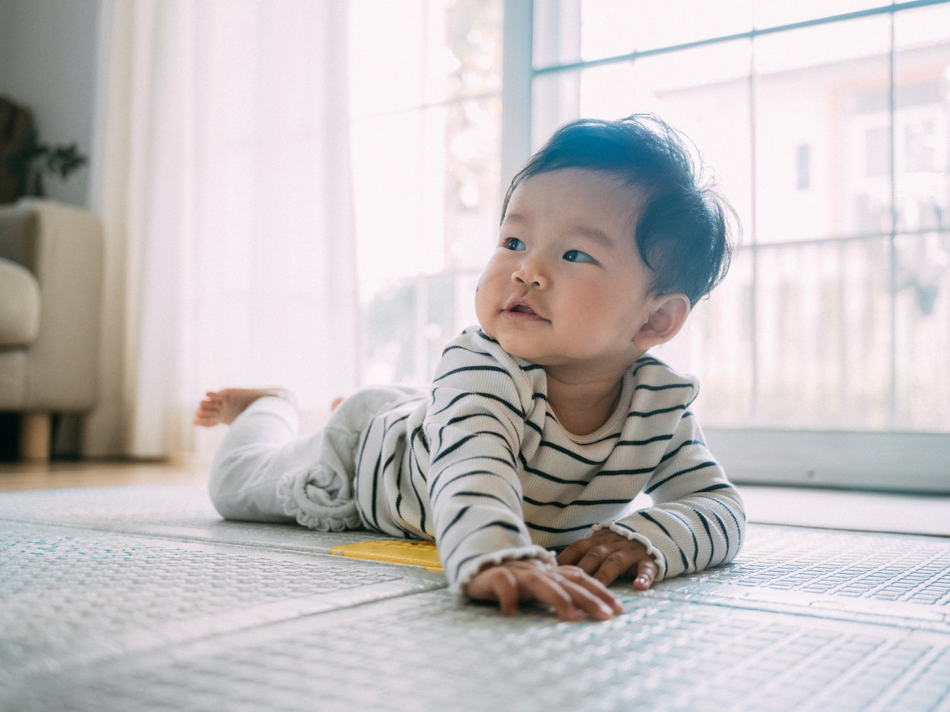 Baby crawling in a striped shirt