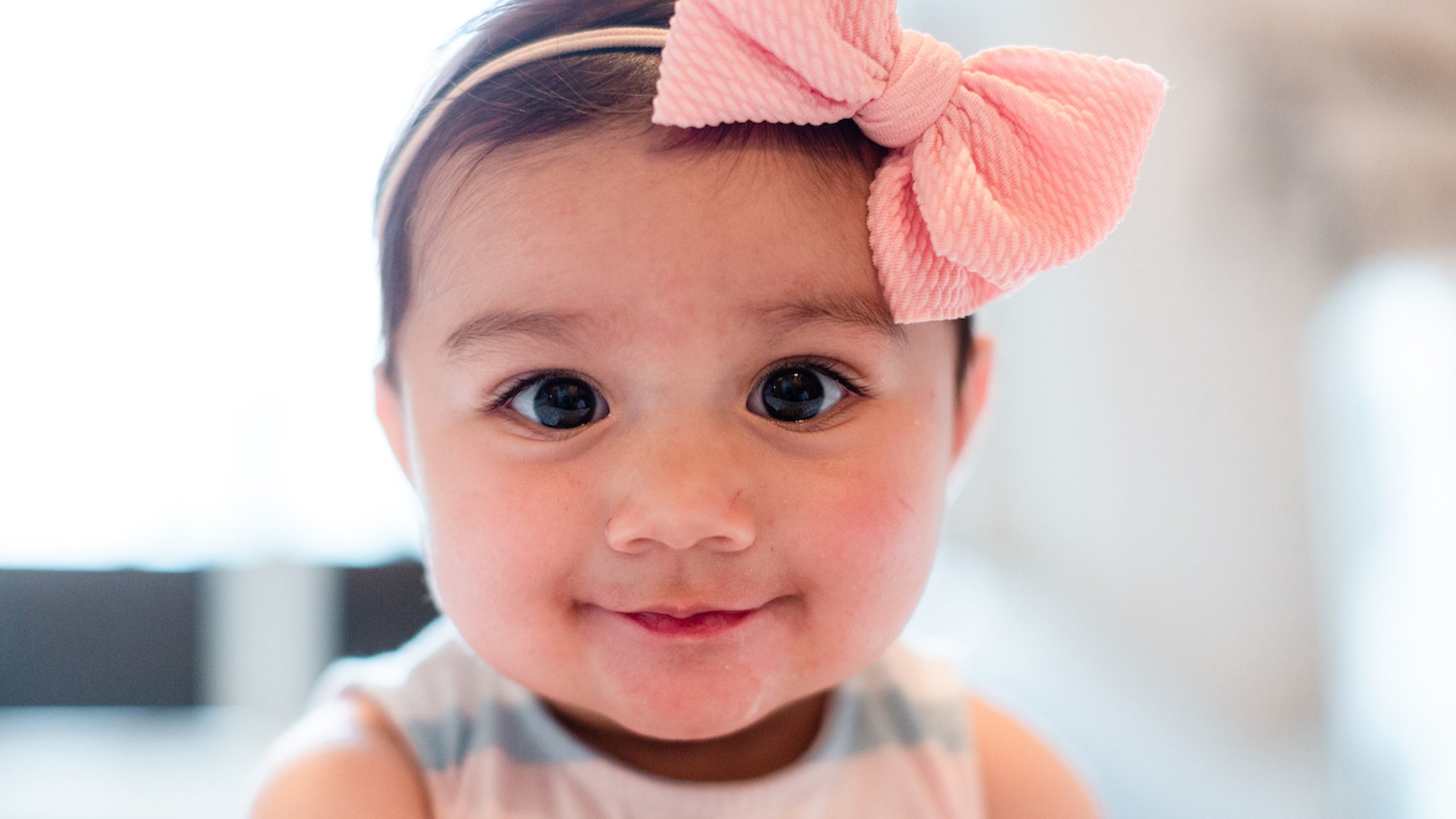 Baby girl with a pink bow