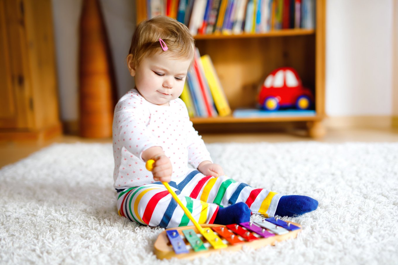 Baby playing with a musical instrument