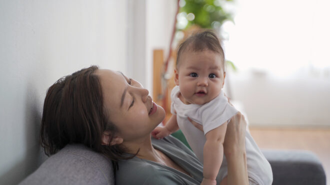 mom holding newborn happy
