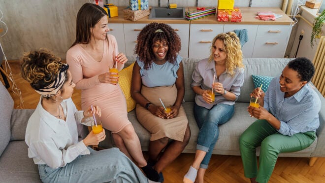 women sitting on couch at baby shower