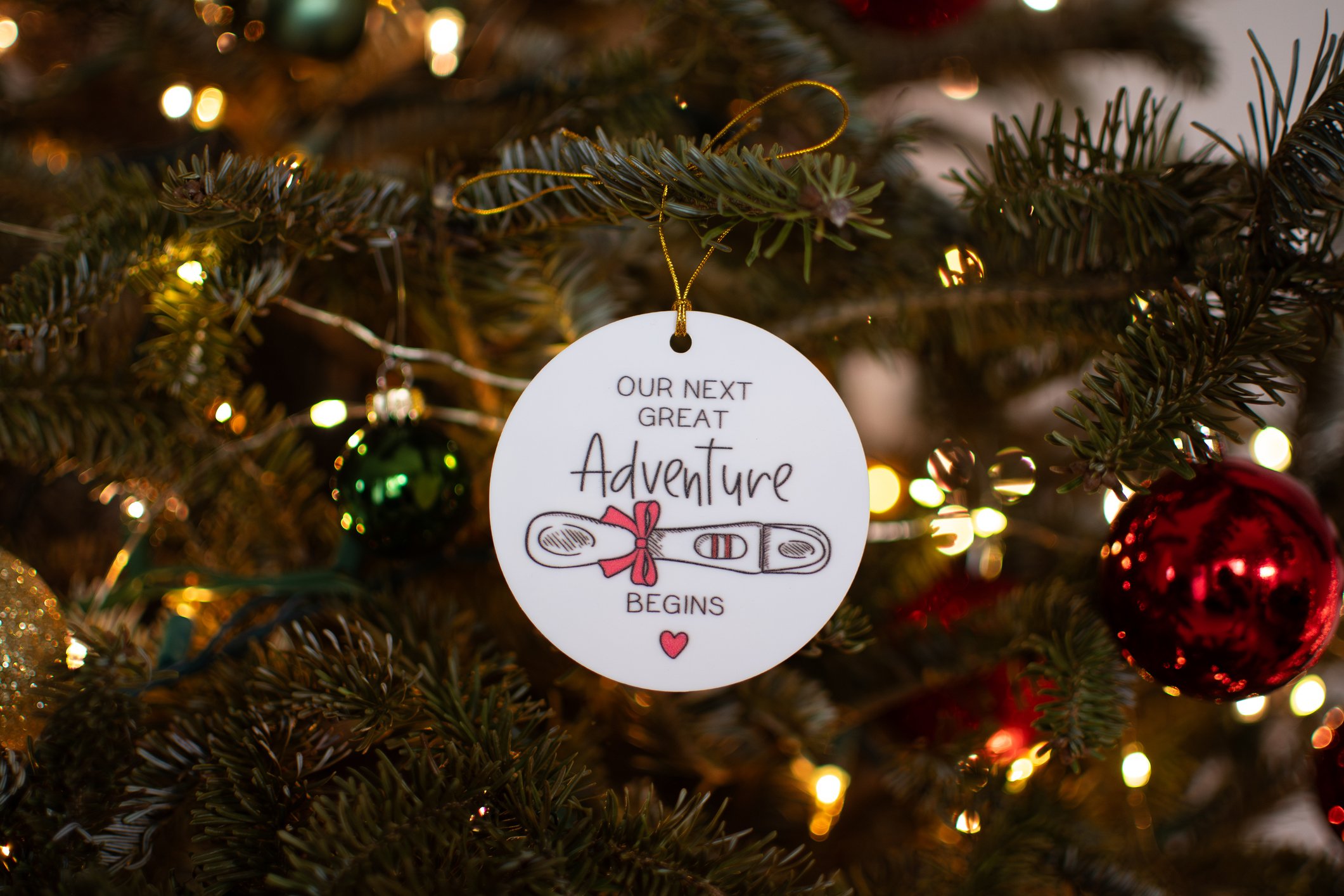 Pregnancy announcement decoration on a Christmas tree. Pregnancy concept. Christmas ornament on a tree pregnancy announcement. Family concept