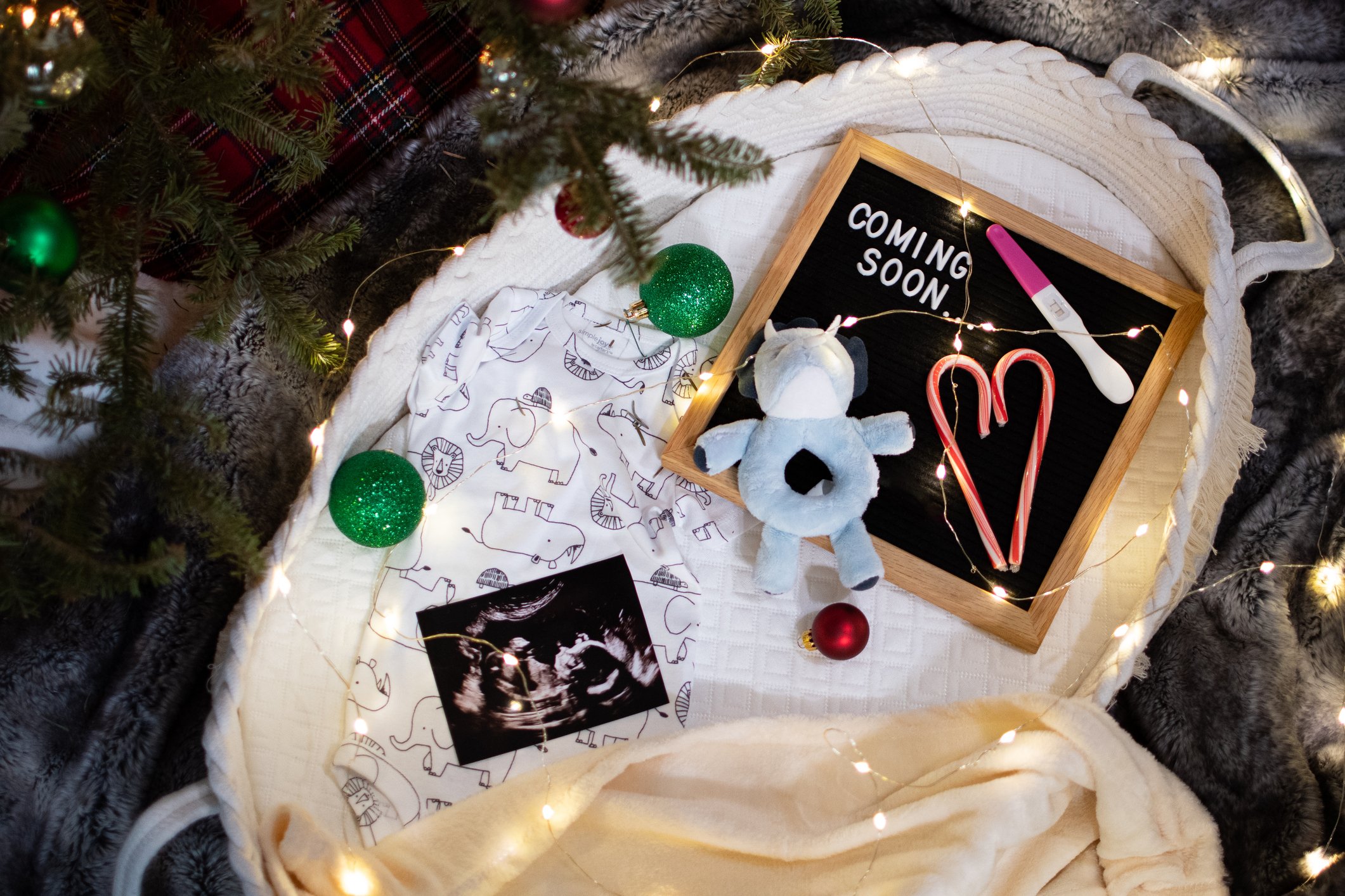 Christmas themed pregnancy announcement. Positive pregnancy test, felt board, sonogram in a basket. Baby on their way!