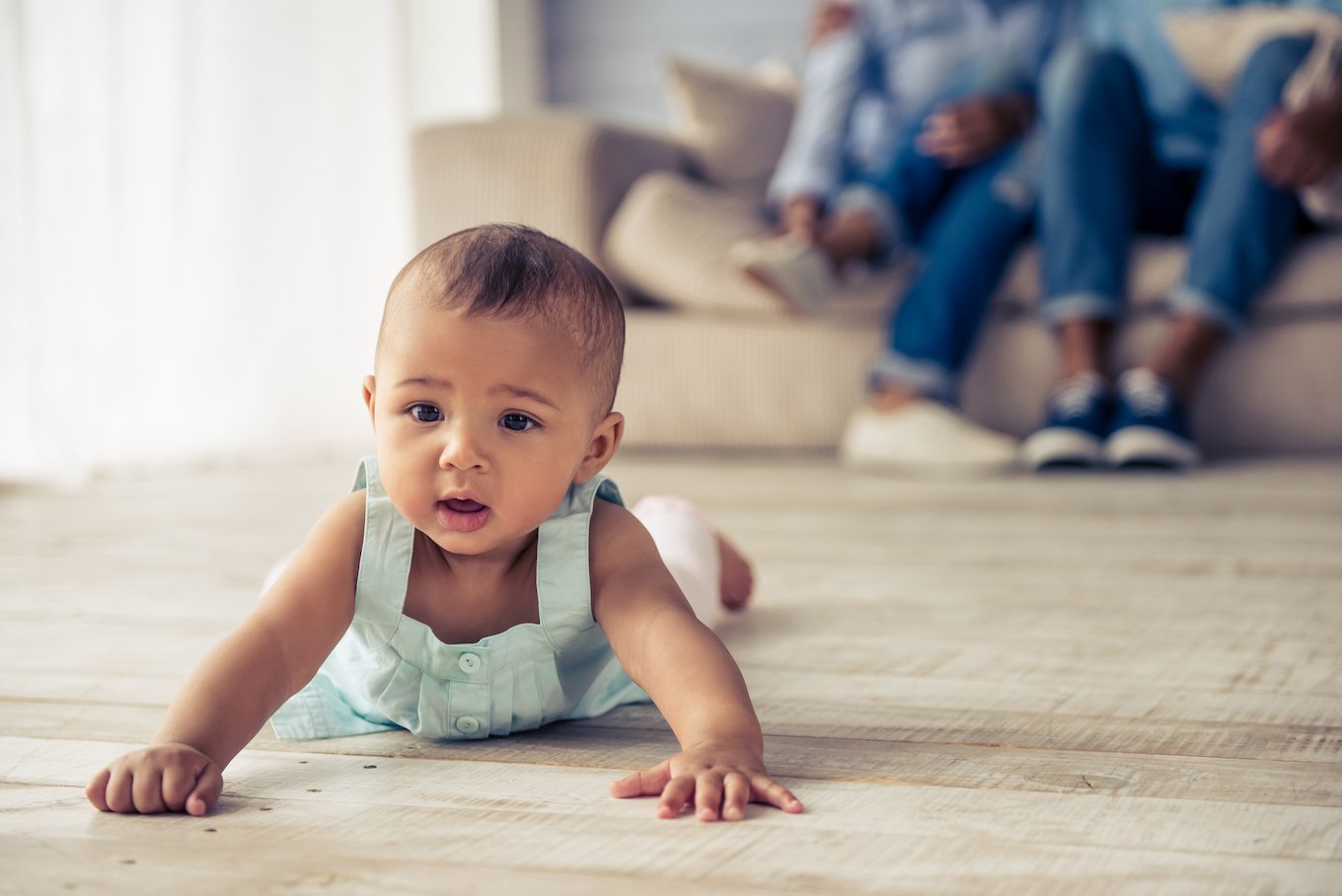 Baby girl crawling on floor