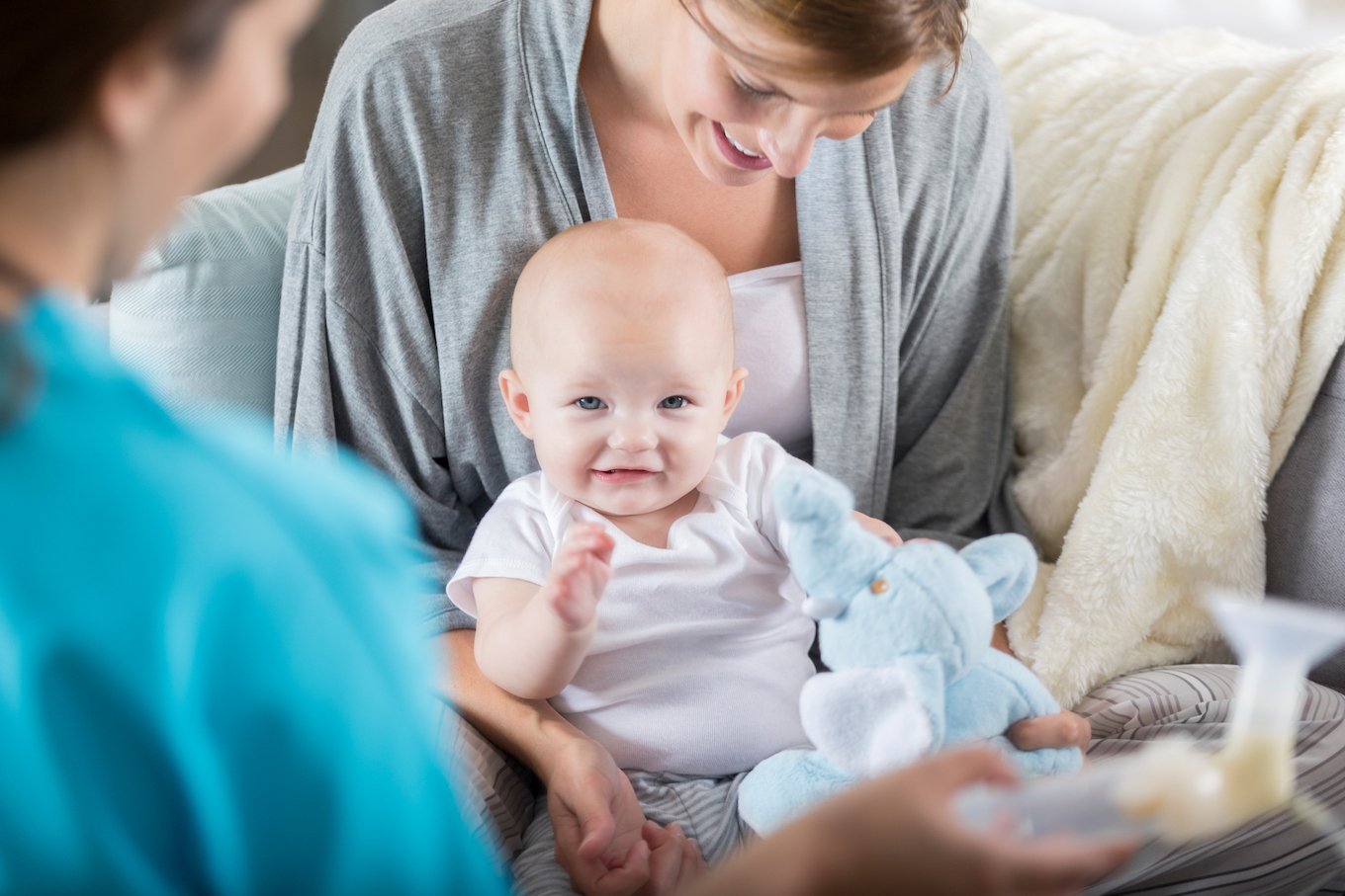 Unrecognizable lactation consultant visits new mom
