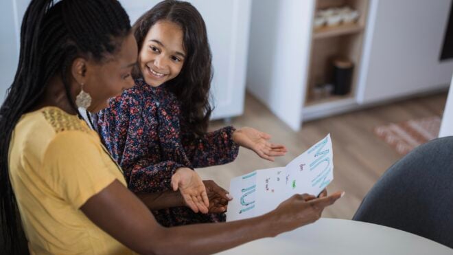 Daughter and mom looking over a chore chart